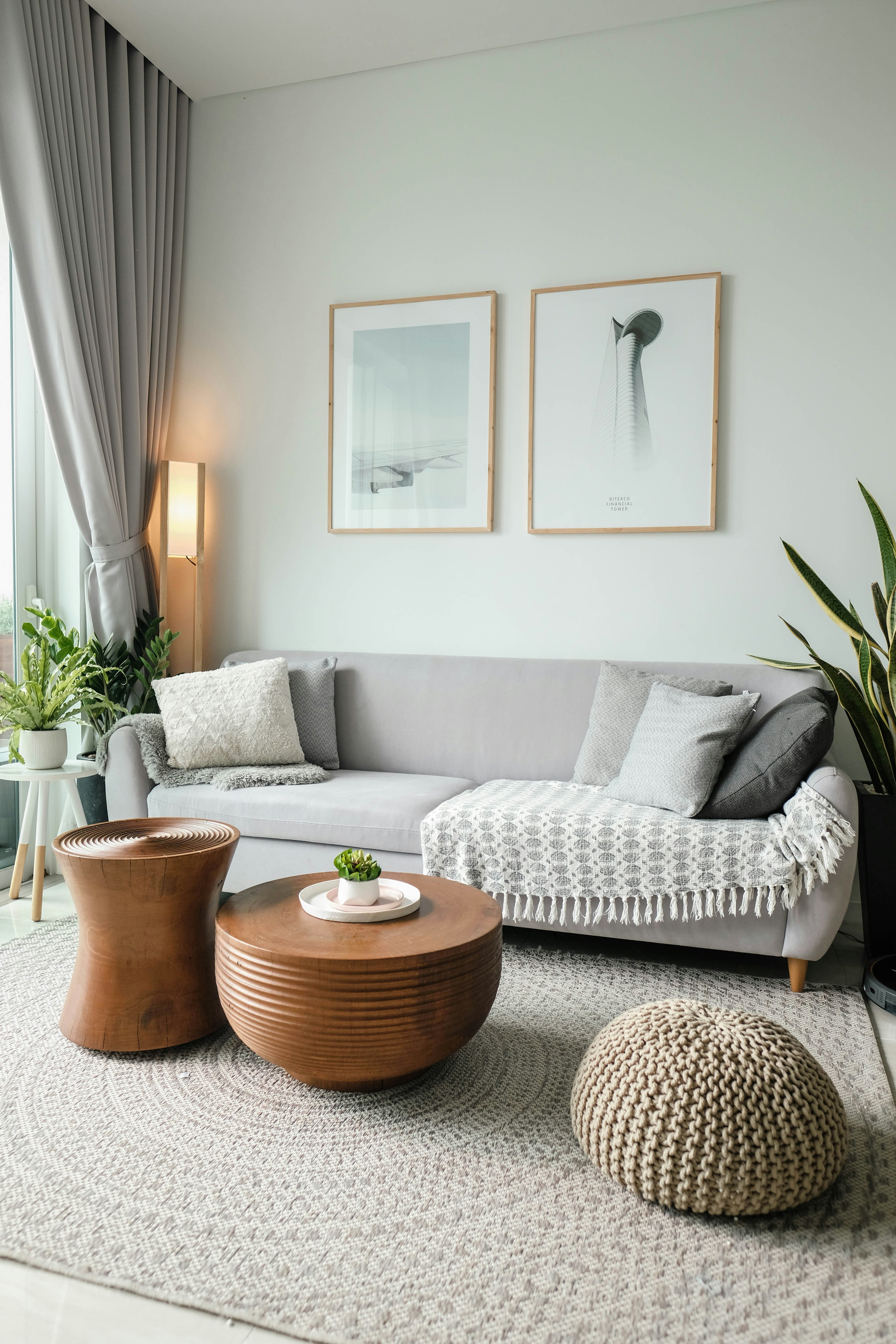 Modern living room with gray sofa, wooden coffee table, and decorative elements.